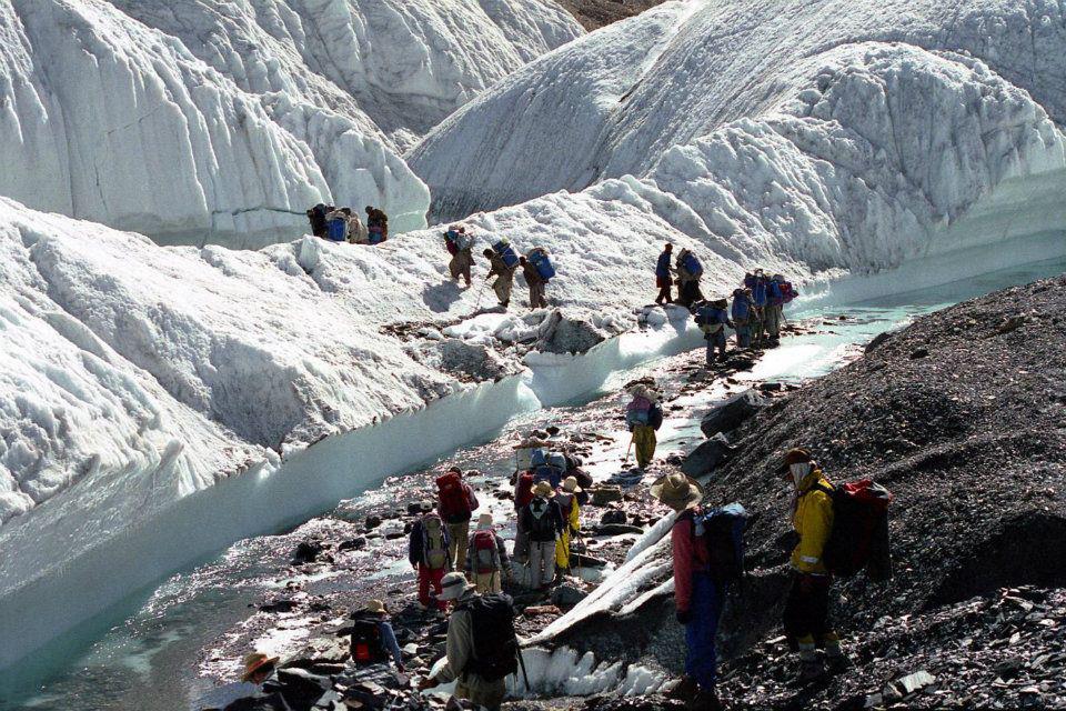 Trekkers crossing baltoro glacier river near concordia - Pakistan